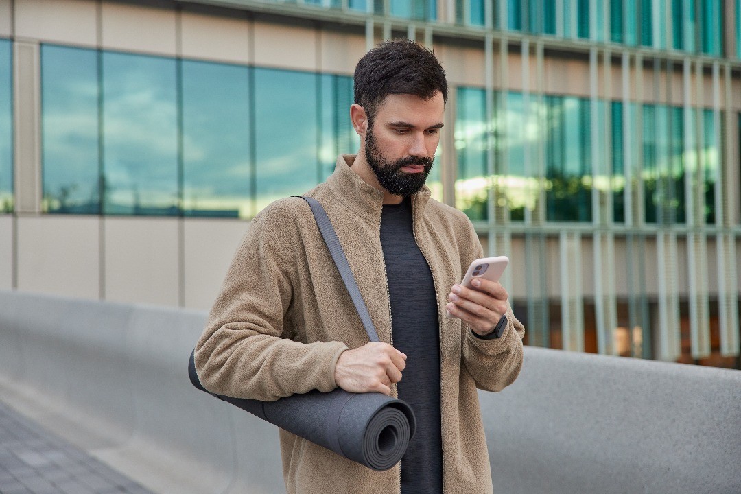 a man is using tidy mood app on his mobile phone